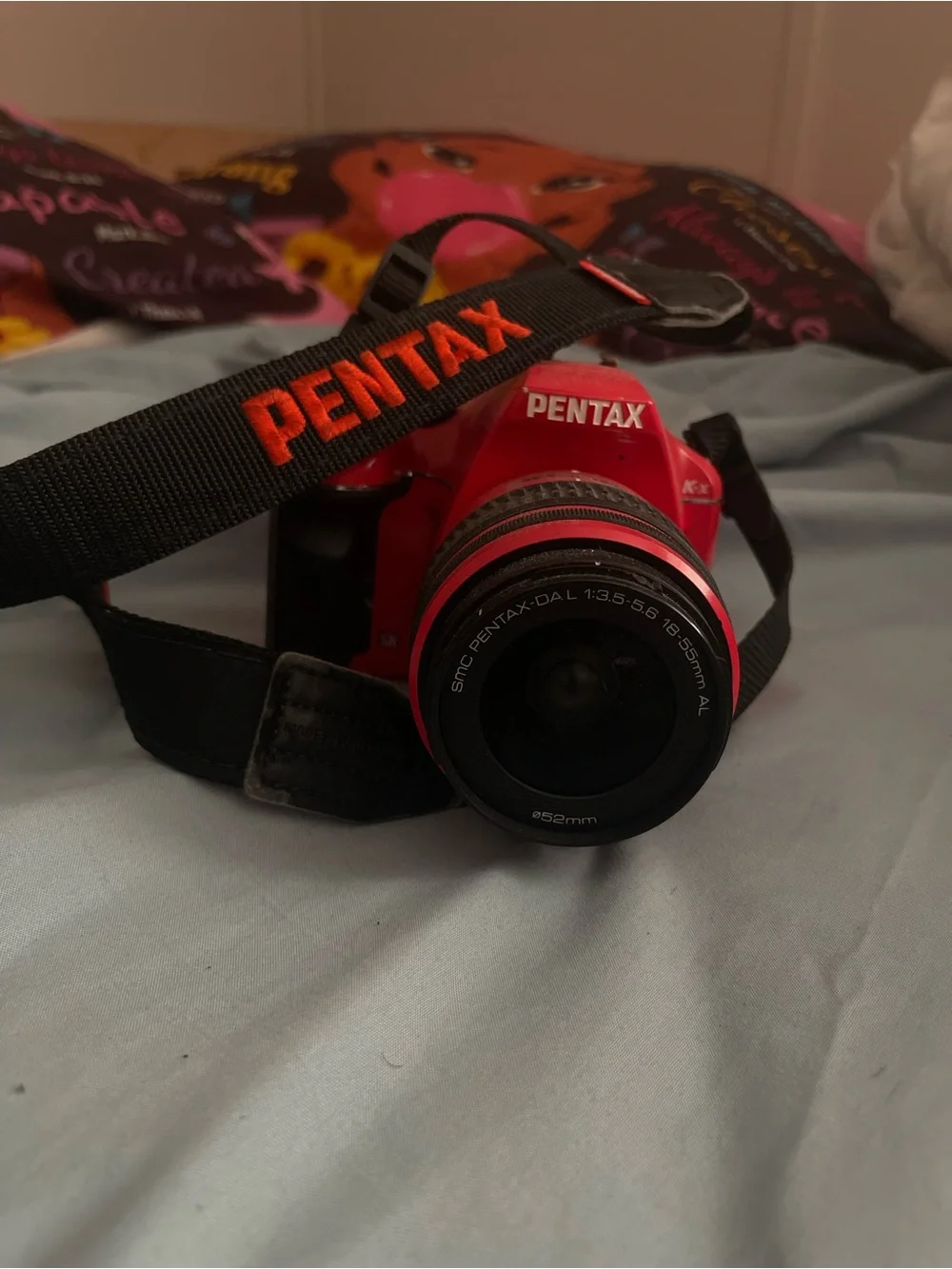 Pentax Red DSLR with Black Strap and 18-55mm Lens